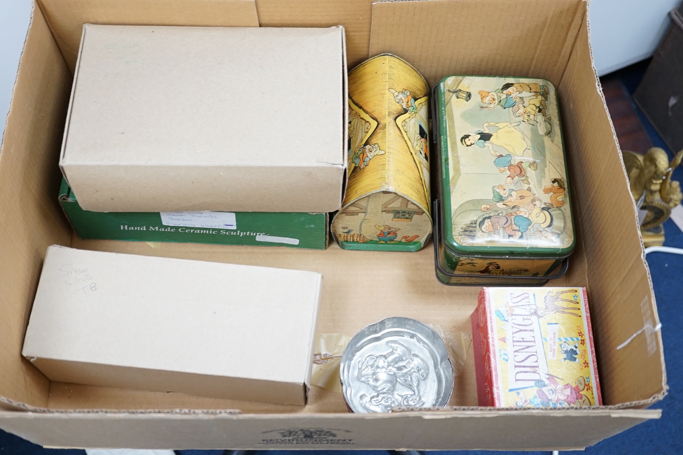 A collection of Disney Snow White memorabilia, including a porcelain set of eight figures by Goebel, W. Germany